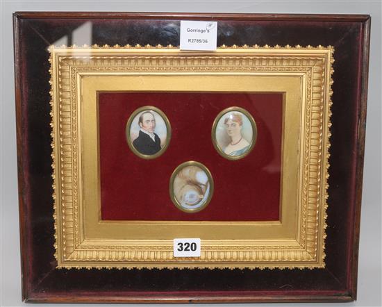 Two Regency oil miniatures on ivory of a lady and gentleman, framed together with a memorial lock of hair (3)	